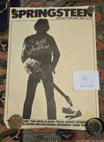 Full view of poster showing design, dimensions note, paperweights