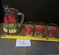 Pitcher and three glasses together showing size reference
