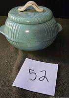 Covered bowl with lid in place showing ribbed body and handle