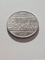 Reverse of coin featuring 1867 Confederation scene with inscriptions