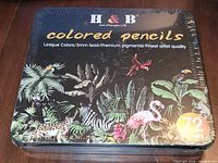 Front of sealed H&B coloured pencil tin showing branding and tropical design