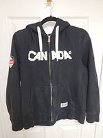 Front view showing CANADA appliqué and zipper