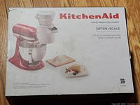 Front of unopened KitchenAid Sifter + Scale attachment box