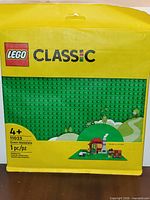 Front of sealed LEGO Classic 11023 green baseplate package