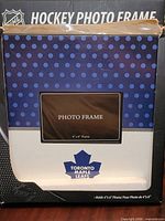 Front of boxed Toronto Maple Leafs photo frame showing design, logo and size