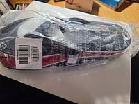 Sealed package containing navy blue Old Navy flip-flops