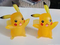 Two translucent Pikachu figures front view