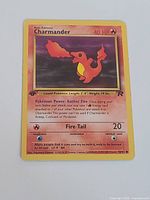 Front view of Charmander Team Rocket 1st Edition card showing artwork, set symbol, card number