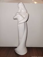 Front view of white porcelain mother and child figurine