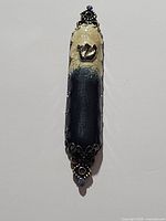 Front view of mezuzah case showing design and Hebrew letter