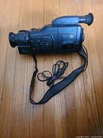 Full view of camcorder with strap and bundled cord
