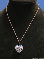 Full view of necklace on display bust showing 18 in. chain and heart pendant