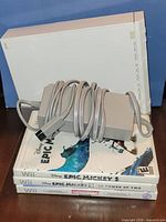 Wii console, three game cases, AC adapter