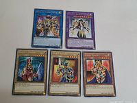 Group of five Yu-Gi-Oh cards laid out on table