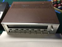 Front view of Sansui stereo receiver showing tuner dial and control knobs