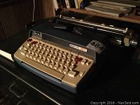 Photo showing the Smith Corona Electra 120 typewriter's keyboard and carriage area, highlighting the general condition and layout of keys.