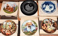 Six Edwin M. Knowles collector plates in original boxes showing detailed combed colors and different themes including children, animals, and celestial designs.