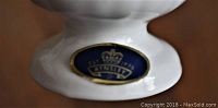 Close-up of Aynsley English fine bone china stamp with crown and logo on base.