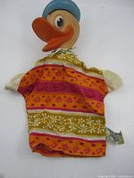 Full view of puppet showing vinyl head, cloth body, overall condition