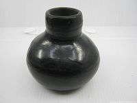 Front view of black pottery vase