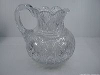 Side view of clear American Brilliant Cut crystal pitcher showing overall form and cut pattern