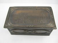 Top view showing embossed cathedral scene and border