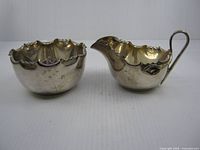 Front view of creamer and sugar bowl showing overall form and finish