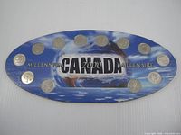 Full view of oval display board with 12 coins inserted