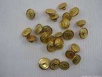 Front view of assorted gold-tone Canadian Military uniform buttons