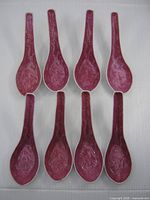 Top view of eight dragon design spoons aligned