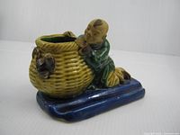 Front/side view of ceramic mudman pen rest