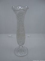 Full view of clear cut crystal bud vase standing upright