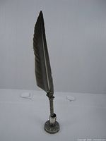 Full view of feather quill in stand