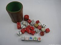 Dice cup and assortment of dice spread out