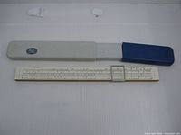 Slide rule beside two-piece plastic case