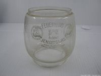 Front view of glass globe showing printed logos and overall shape