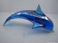 side view of blue glass dolphin showing body profile and fins