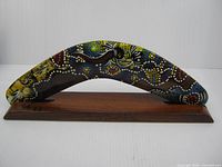 Full view of painted boomerang on stand