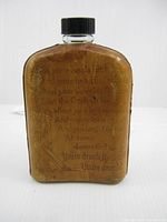 Front of leather wrapped flask with poem