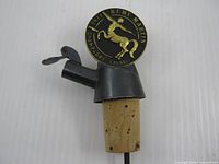 Front view of Rémy Martin pourer showing medallion, spout and cork