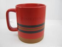 Front view showing Pendleton logo and stripe design on red mug