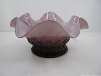 Side view showing ruffled rim and scalloped body