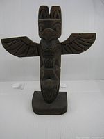 front view of carved totem pole with wings spread