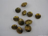 Group of 11 brass uniform buttons with assorted Army Medical and Signals insignias
