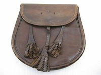 Front view of brown leather sporran with tassels