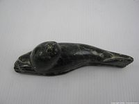 Top view of soapstone seal carving showing overall form and surface wear