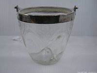 Full view of etched crystal ice bucket with silver-plate rim and handle
