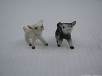 front view of both lamb figurines showing colors and stance