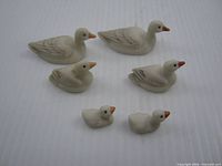 Six ceramic bird figurines in three sizes