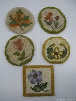 All five hooked wool coasters displayed together